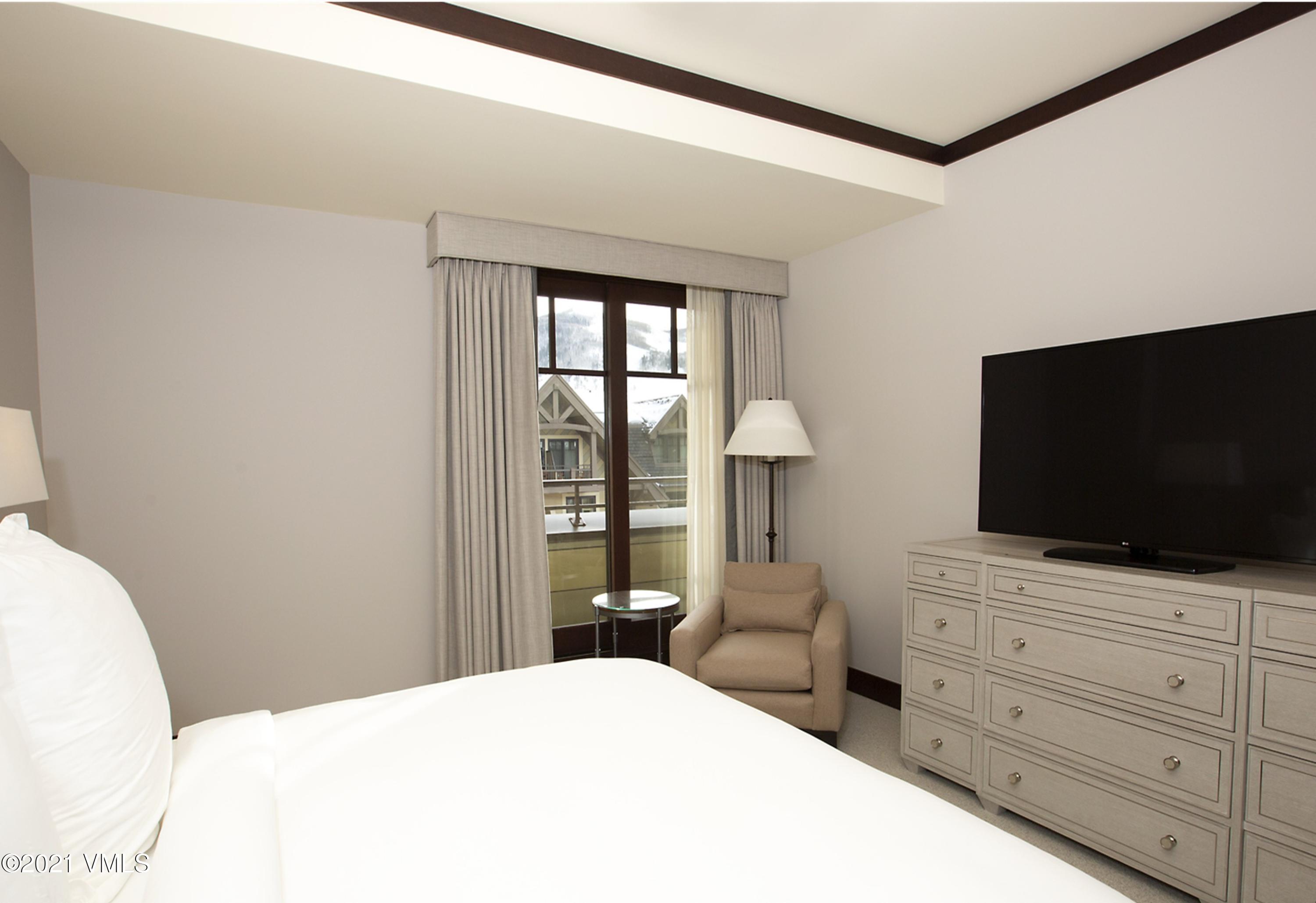 1 Vail Road, Unit 6102D Vail, CO 81657 - Photo 6 of 9 a bedroom with a bed and a flat screen tv
