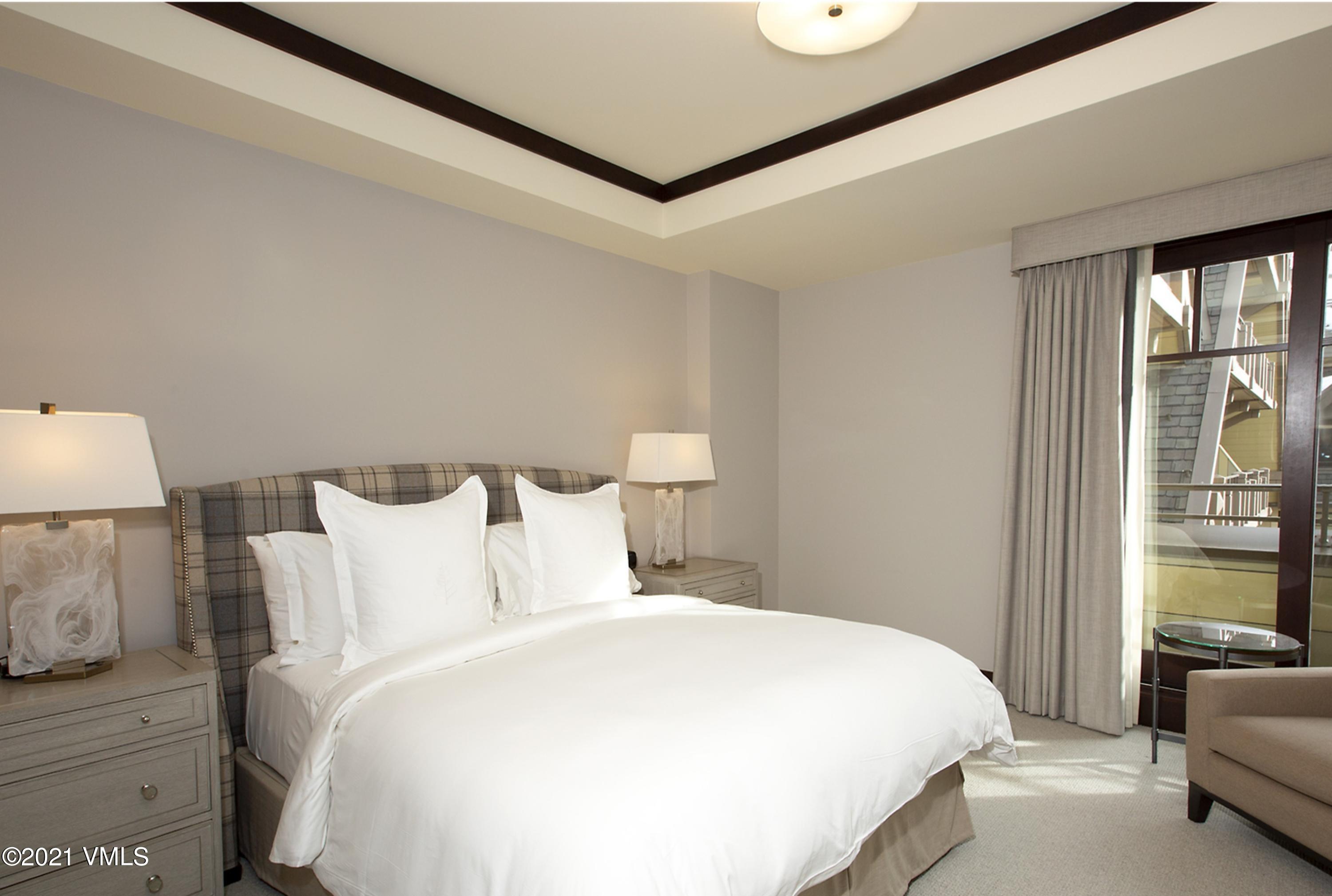 1 Vail Road, Unit 6102D Vail, CO 81657 - Photo 7 of 9 a bedroom with a large bed and a large window with outer view
