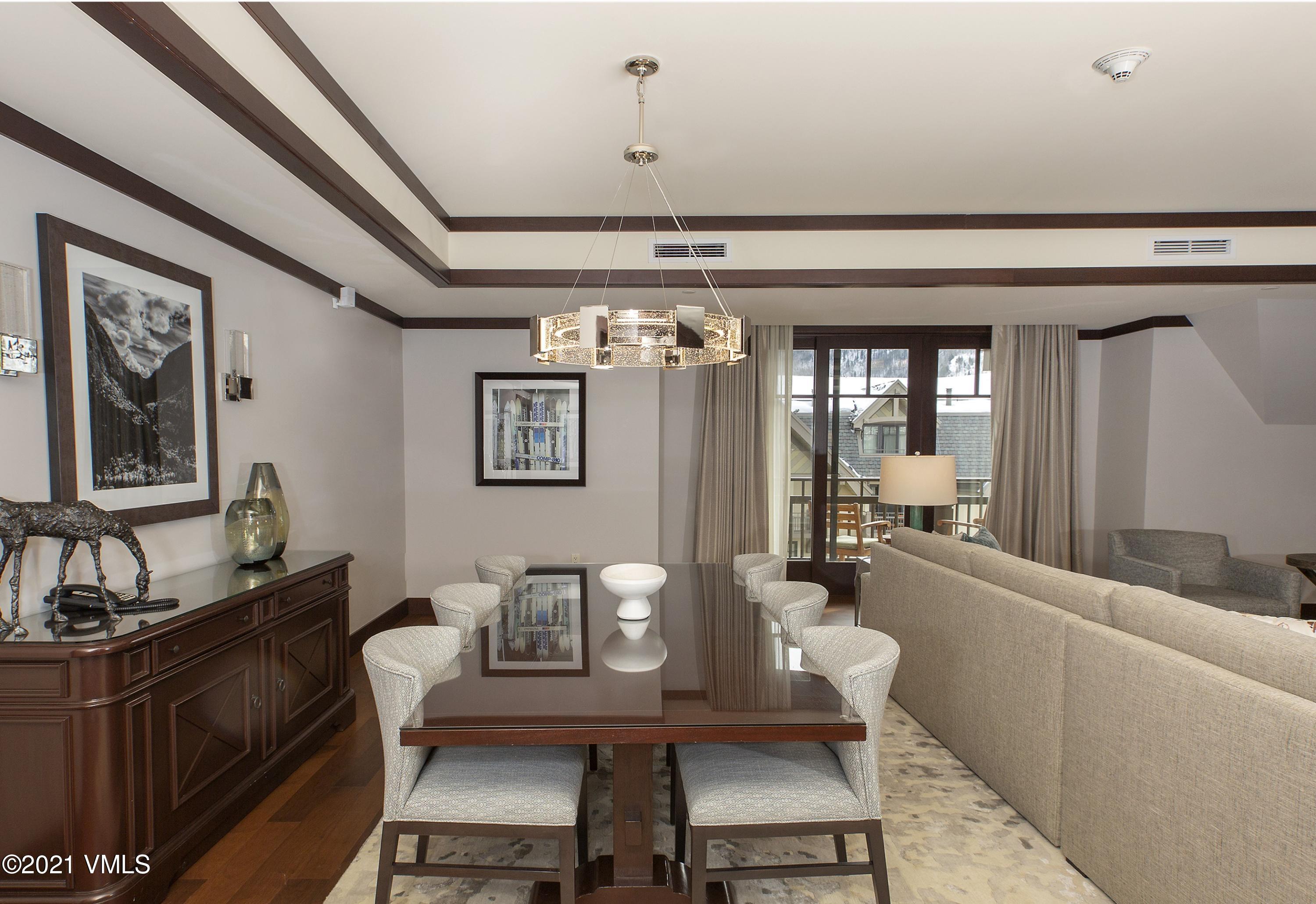 1 Vail Road, Unit 6102D Vail, CO 81657 - Photo 9 of 9 a living room with furniture and a chandelier