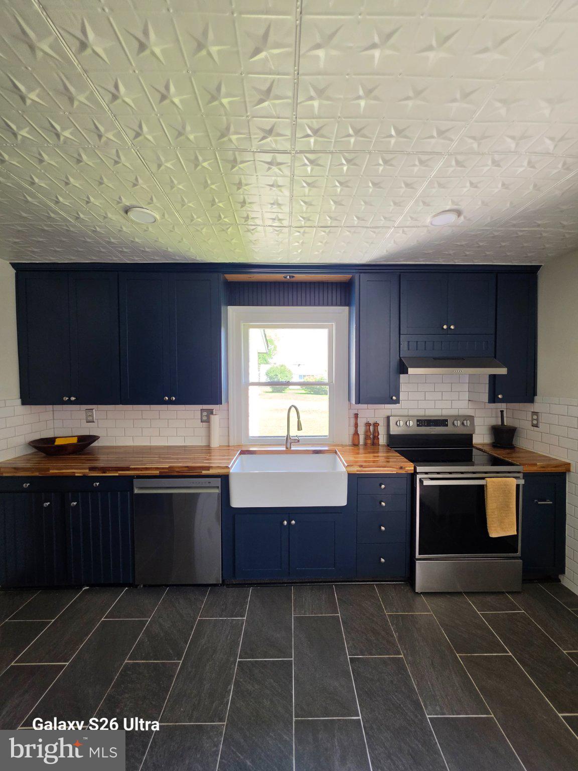 22729 Rapidan Road Mitchells, VA 22729 - Photo 24 of 39 Charming navy kitchen with modern flair.