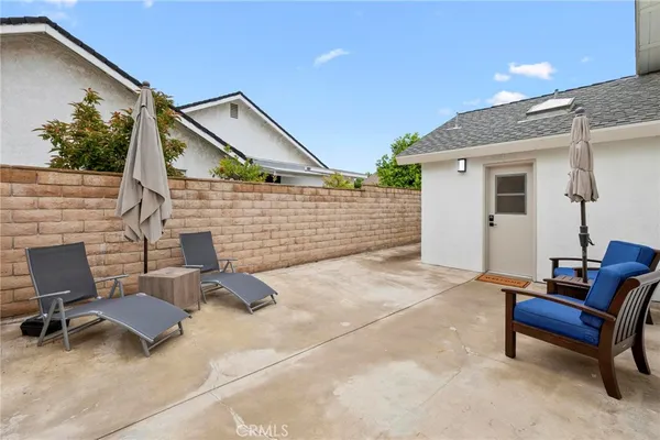 a view of a patio with a table and chairs