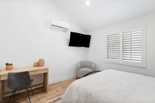 a bedroom with a bed and a chair