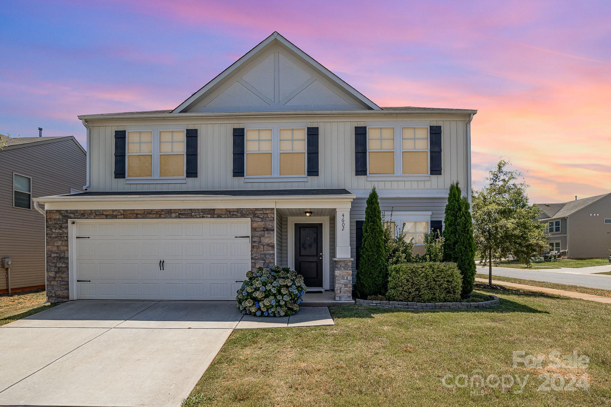 a front view of a house with a yard and garage