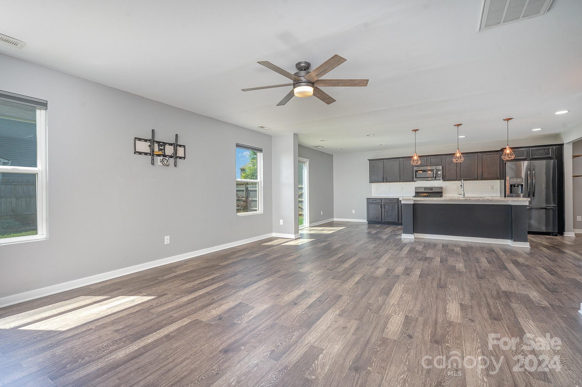 4602 Gibbons Link Road Charlotte, NC 28269 - Photo 12 of 35 a view of kitchen and window with wooden floor
