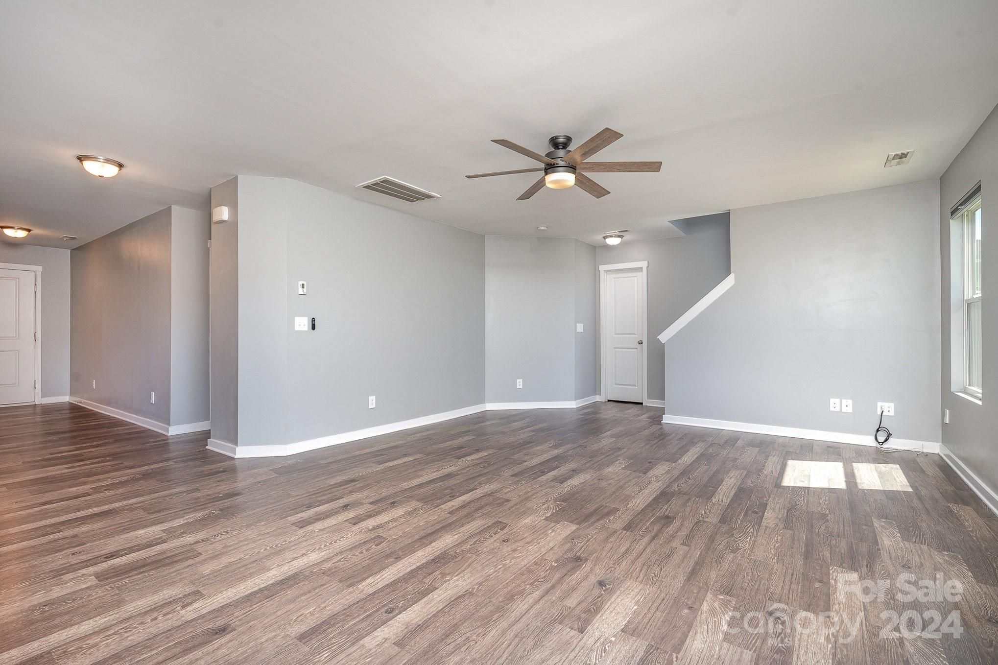 4602 Gibbons Link Road Charlotte, NC 28269 - Photo 14 of 35 a view of empty room with wooden floor and fan
