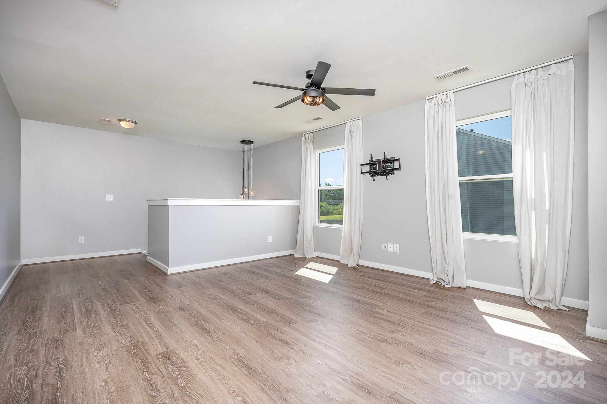 4602 Gibbons Link Road Charlotte, NC 28269 - Photo 16 of 35 wooden floor in an empty room with a window