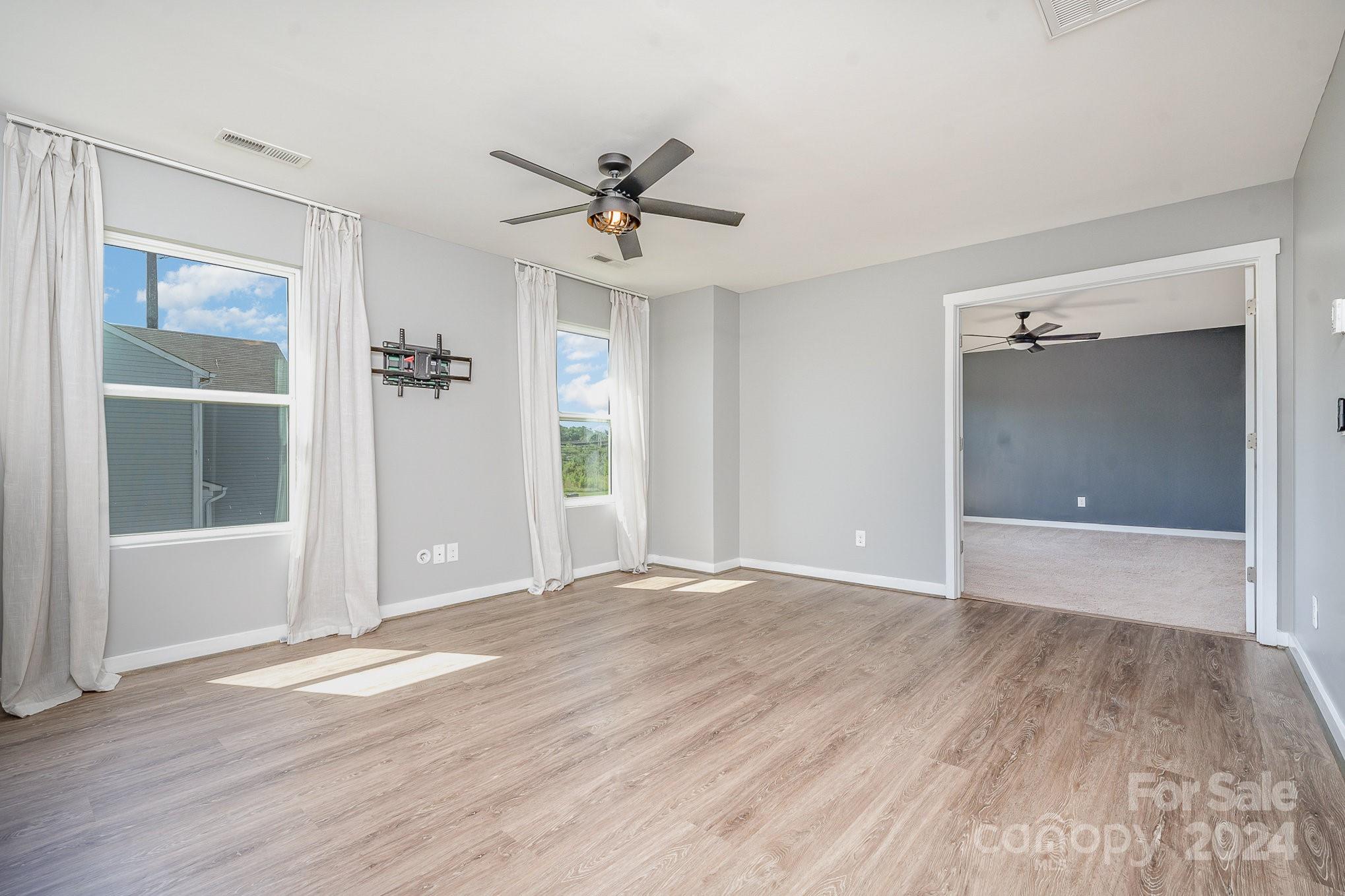 4602 Gibbons Link Road Charlotte, NC 28269 - Photo 17 of 35 a view of an empty room with wooden floor and a window