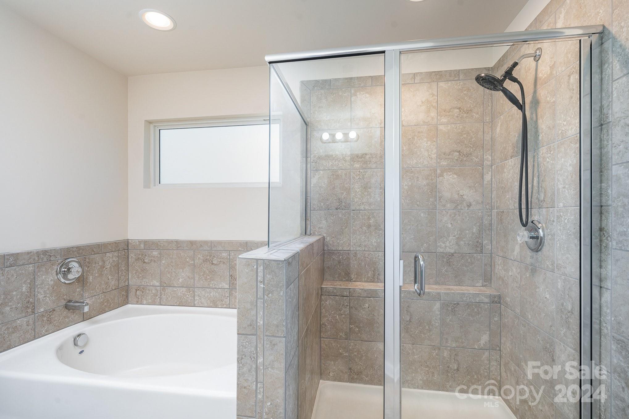 4602 Gibbons Link Road Charlotte, NC 28269 - Photo 21 of 35 a bathroom with a bathtub and a shower