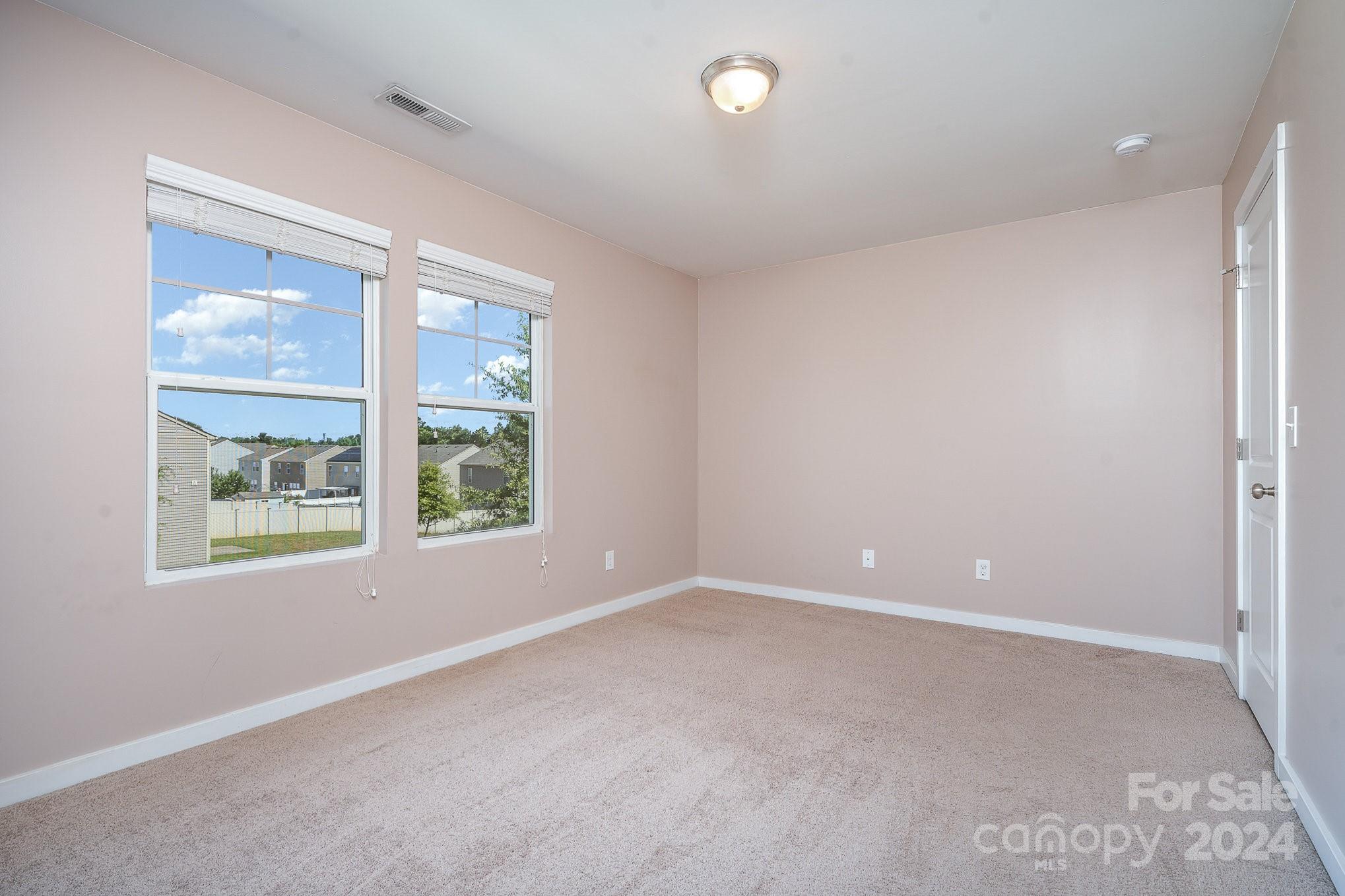 4602 Gibbons Link Road Charlotte, NC 28269 - Photo 24 of 35 an empty room with windows