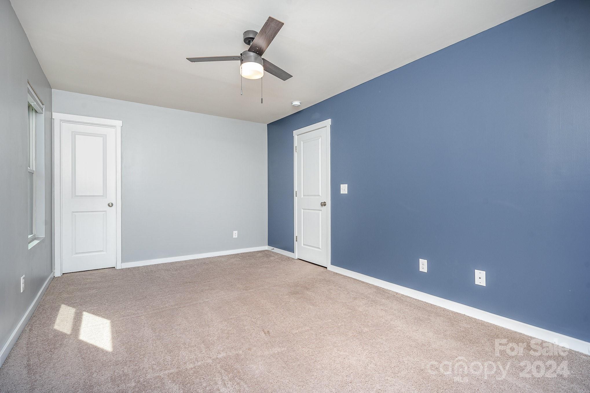 4602 Gibbons Link Road Charlotte, NC 28269 - Photo 26 of 35 a view of an empty room with a chandelier fan