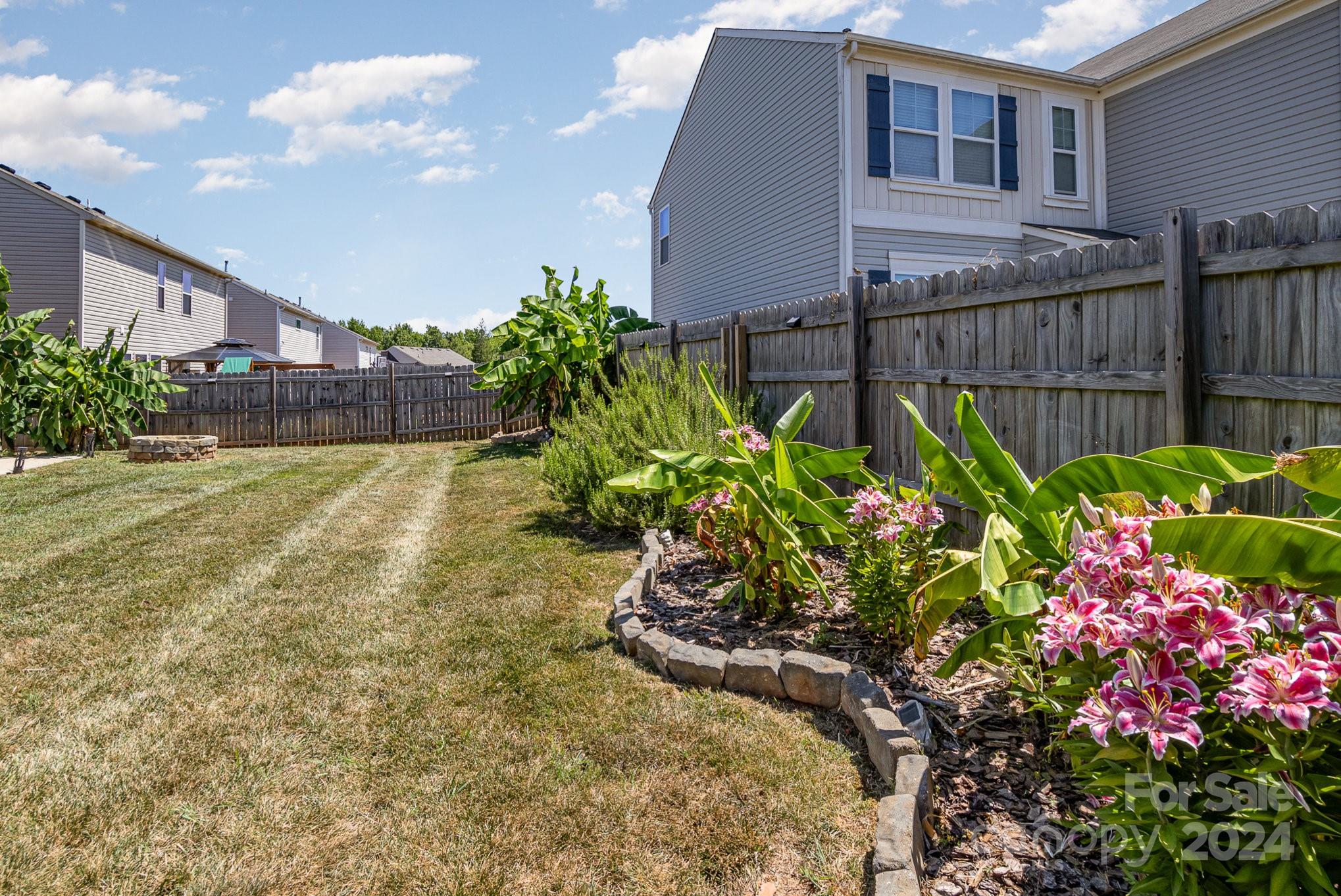 4602 Gibbons Link Road Charlotte, NC 28269 - Photo 29 of 35 a view of a house with a flower garden