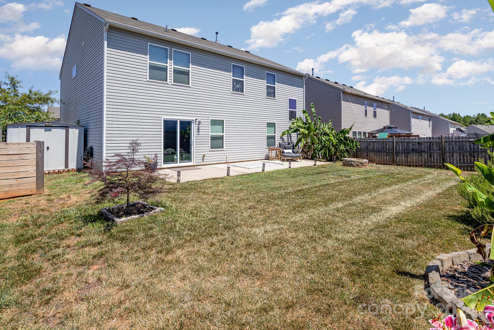 4602 Gibbons Link Road Charlotte, NC 28269 - Photo 30 of 35 a front view of house with yard and trees in the background