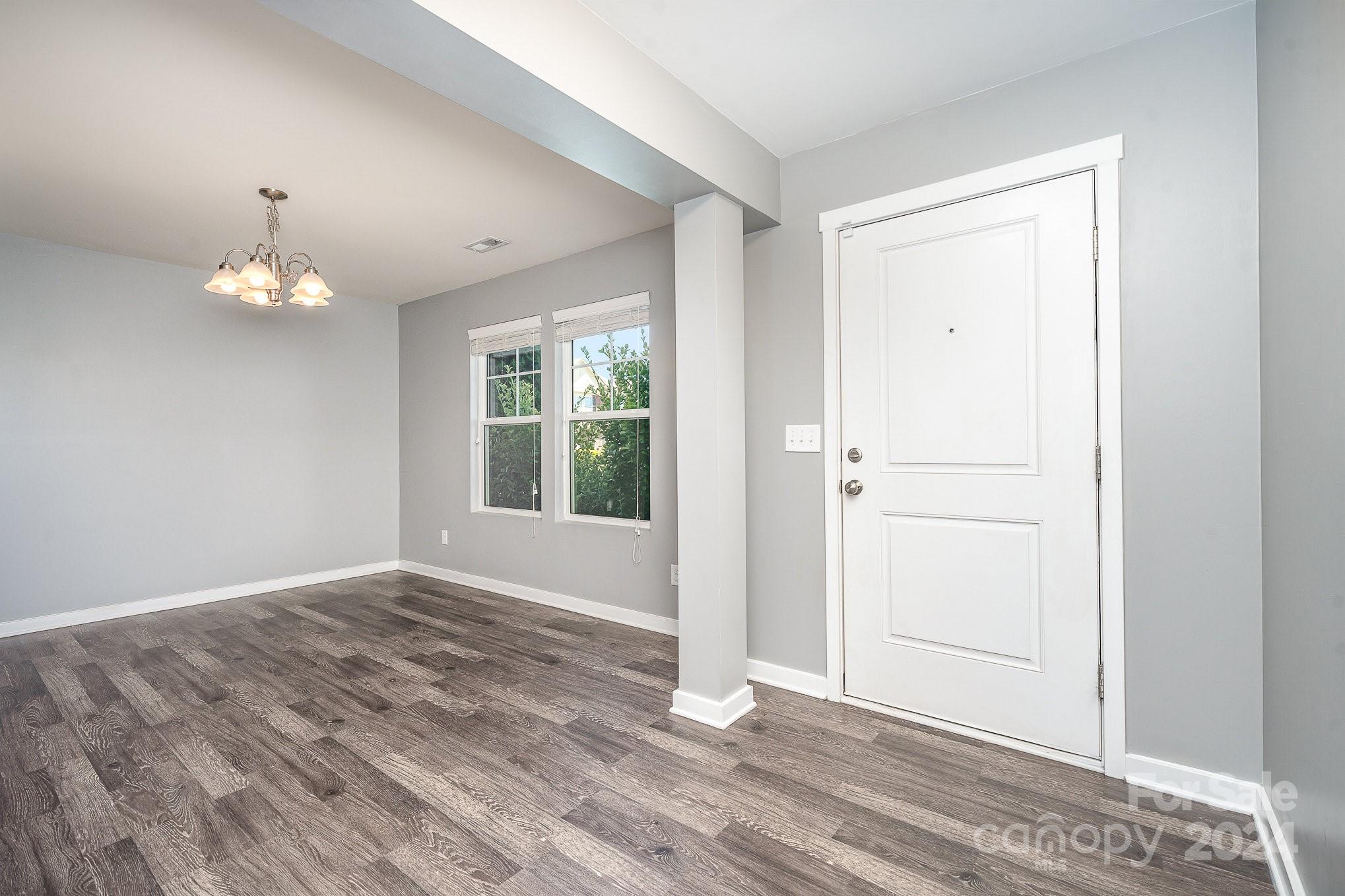 4602 Gibbons Link Road Charlotte, NC 28269 - Photo 3 of 35 a view of an empty room with wooden floor and a window
