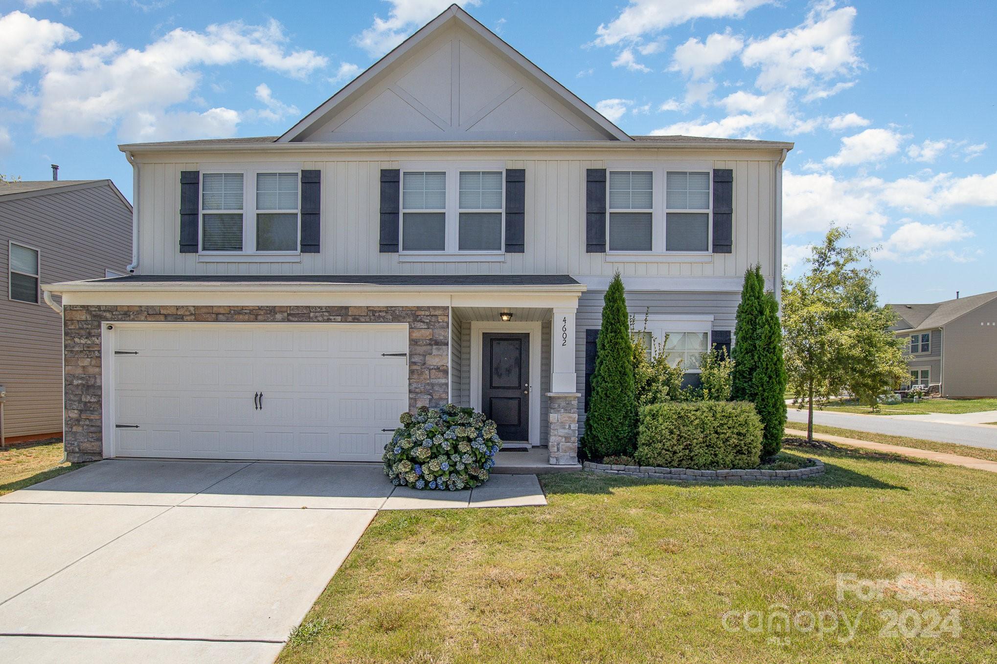 4602 Gibbons Link Road Charlotte, NC 28269 - Photo 33 of 35 a front view of a house with a yard and garage