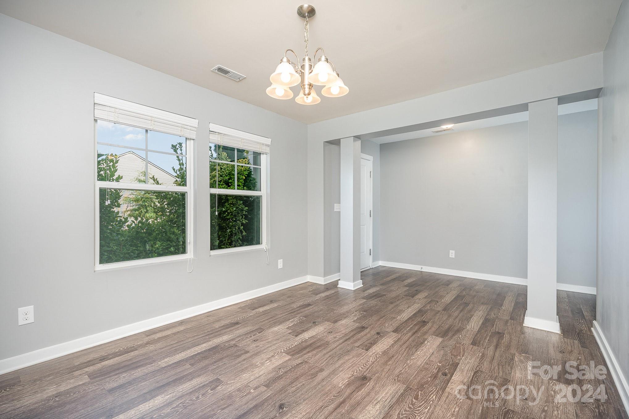 4602 Gibbons Link Road Charlotte, NC 28269 - Photo 4 of 35 a view of an empty room with wooden floor and a window