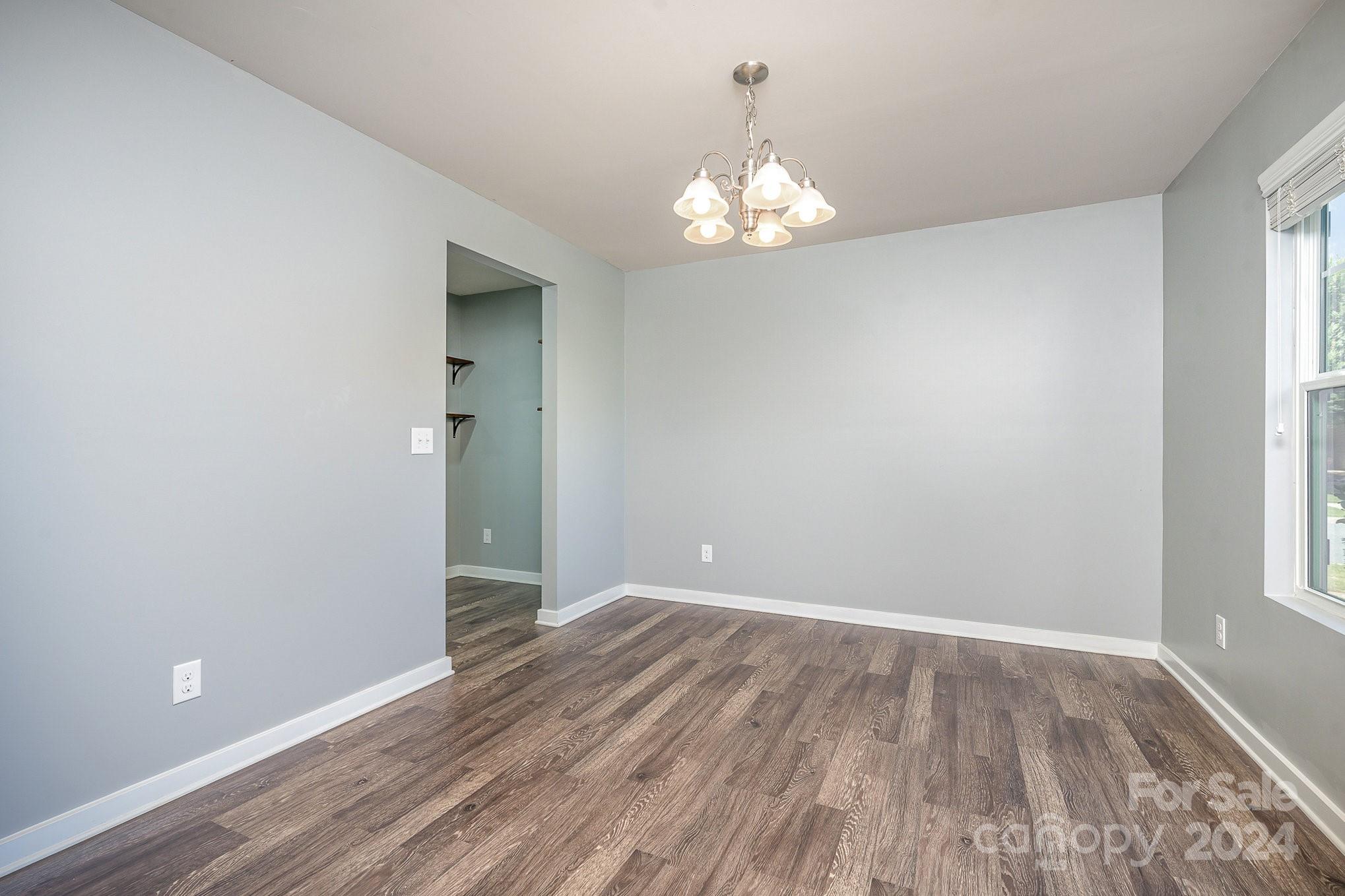 4602 Gibbons Link Road Charlotte, NC 28269 - Photo 5 of 35 wooden floor in an empty room with a window