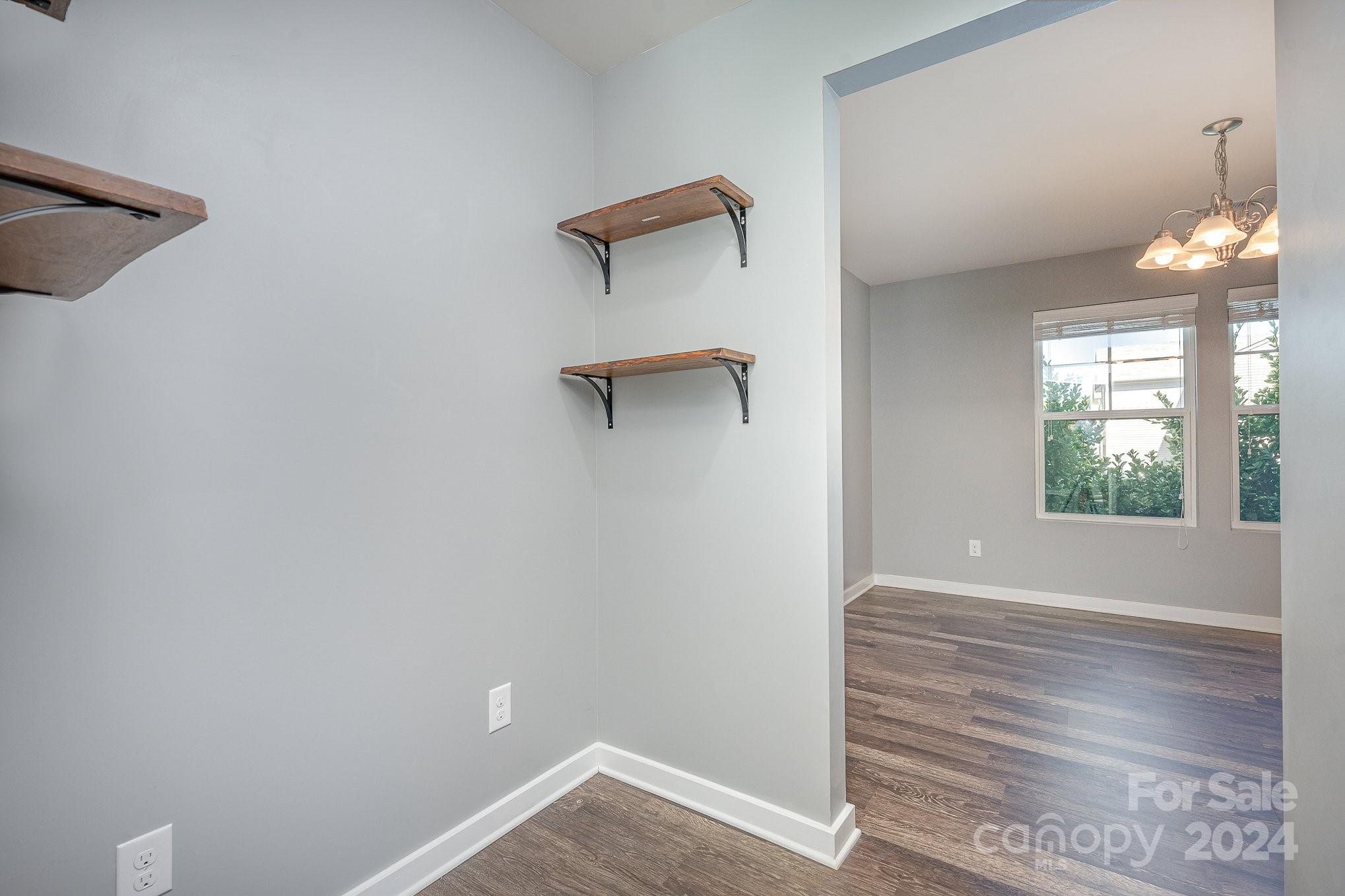 4602 Gibbons Link Road Charlotte, NC 28269 - Photo 6 of 35 a view of an empty room with wooden floor and a window