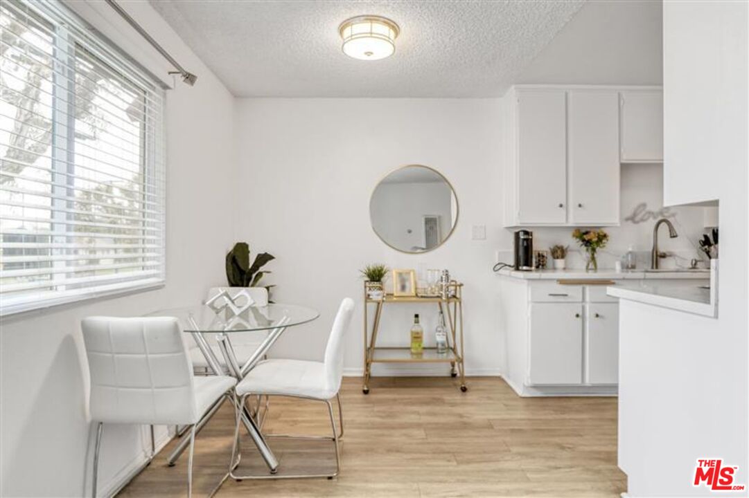 7356 Corbin Avenue Reseda, CA 91335 - Photo 9 of 11 a living room with furniture a window and a clock
