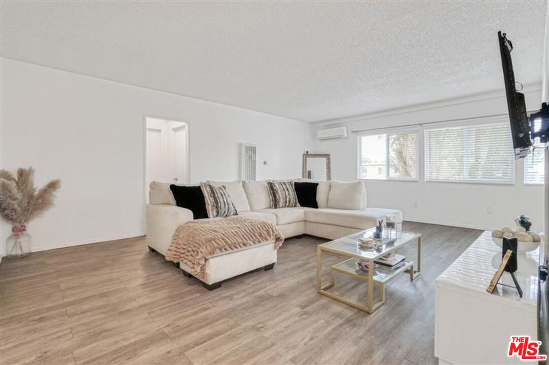 7356 Corbin Avenue Reseda, CA 91335 - Photo 10 of 11 a living room with furniture and wooden floor