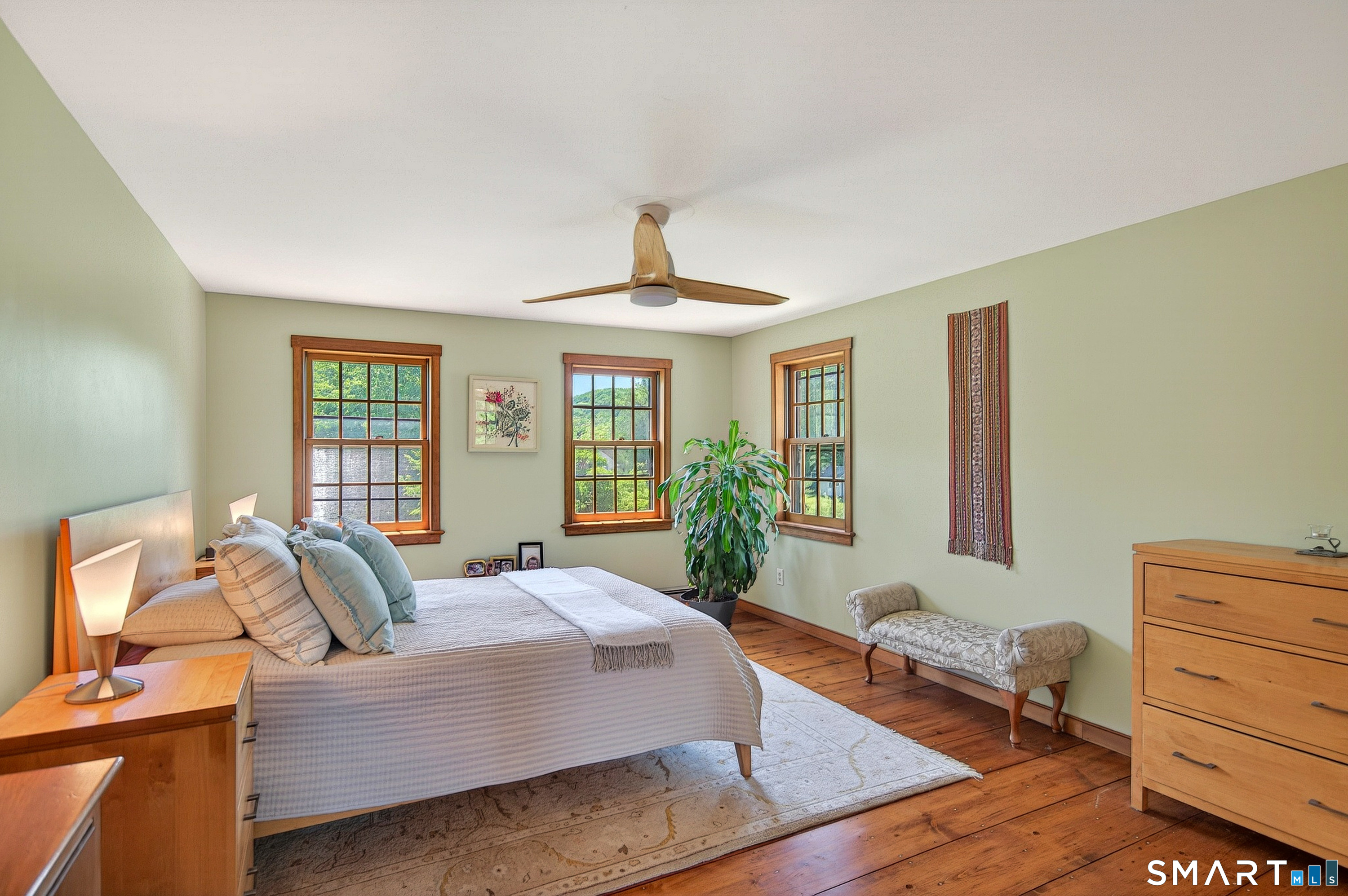 174 Huntingtown Road Newtown, CT 06470 - Photo 22 of 40 a bedroom with a bed and wooden floor