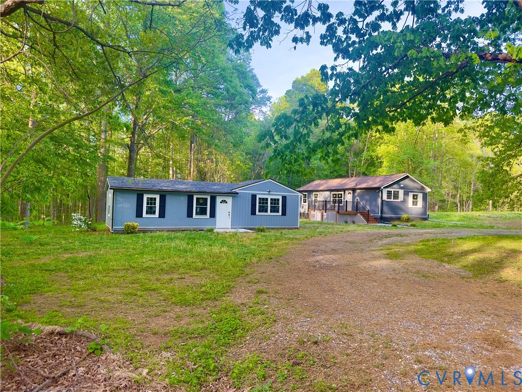 3829 Five Forks Road Pamplin, VA 23958 - Photo 2 of 65 a view of a big house with large trees and a big yard with large trees