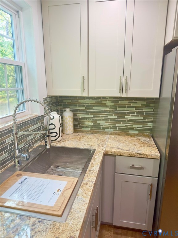 3829 Five Forks Road Pamplin, VA 23958 - Photo 26 of 65 a kitchen with granite countertop a sink a stove and cabinets