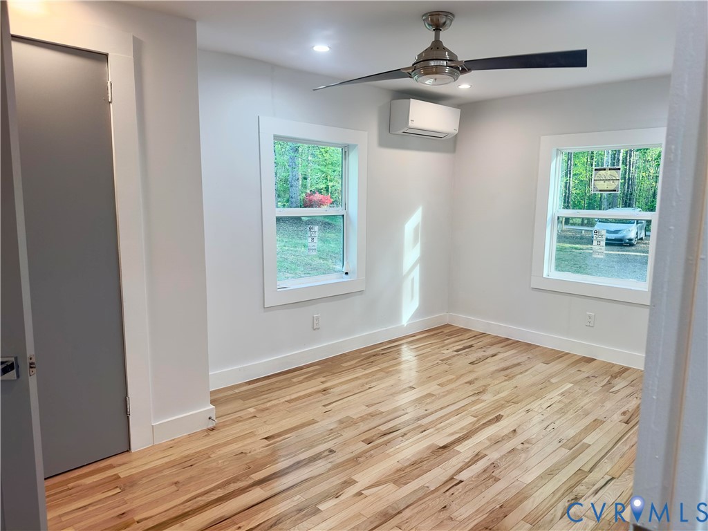 3829 Five Forks Road Pamplin, VA 23958 - Photo 35 of 65 an empty room with wooden floor cabinet and windows
