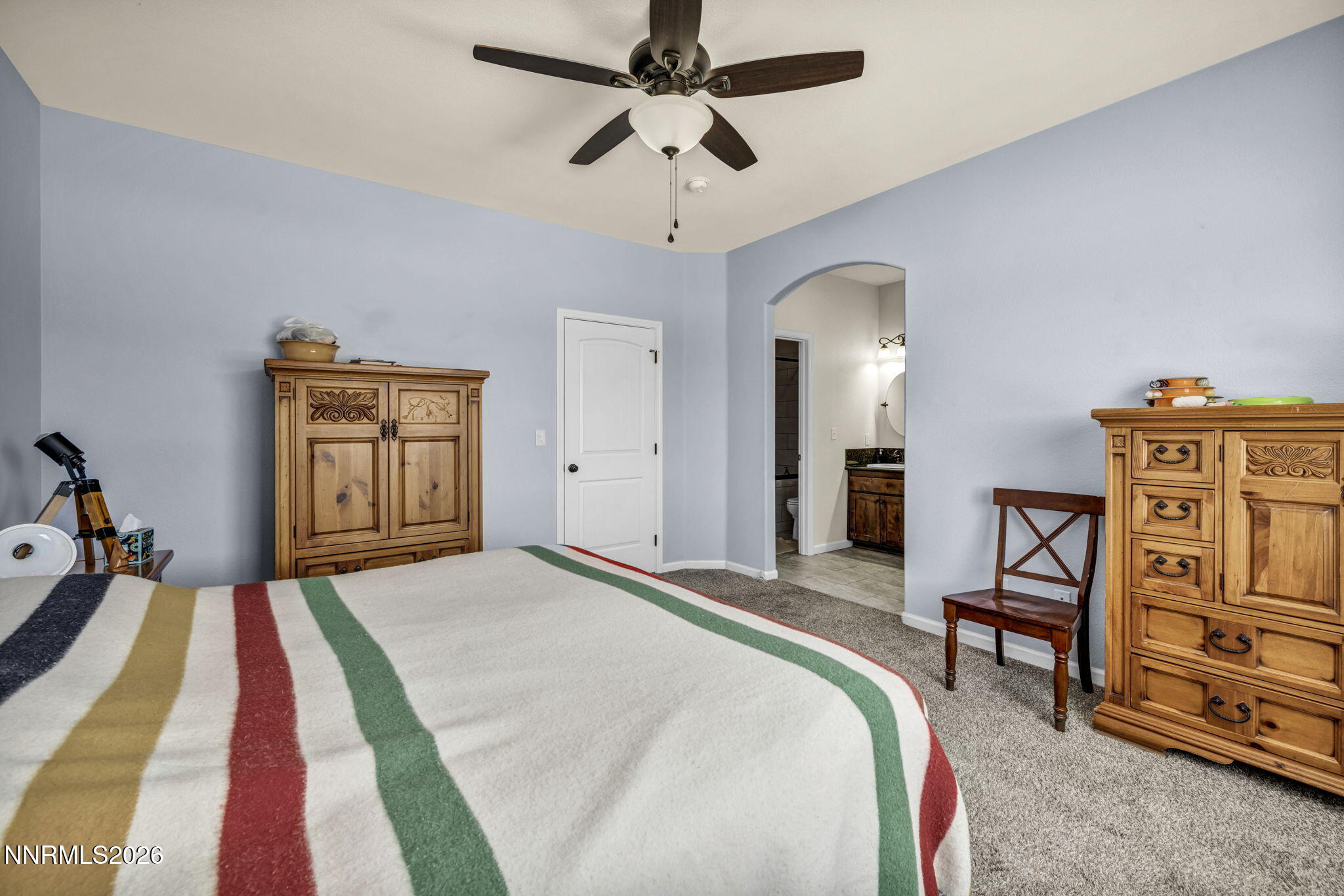 1286 Sky Ridge Drive Fallon, NV 89406 - Photo 22 of 49 a bedroom with a bed and a chandelier