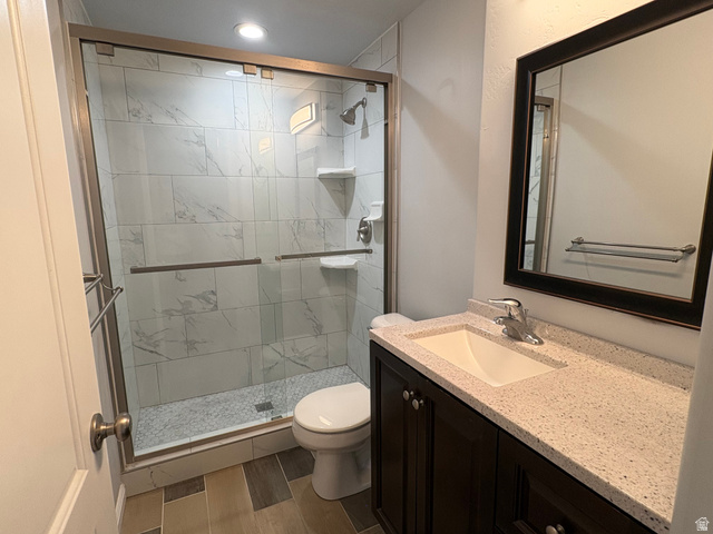 665 West State Road Lehi, UT 84043 - Photo 17 of 30 Bathroom featuring a glass-enclosed shower with white tiled walls and pebble-finish floor