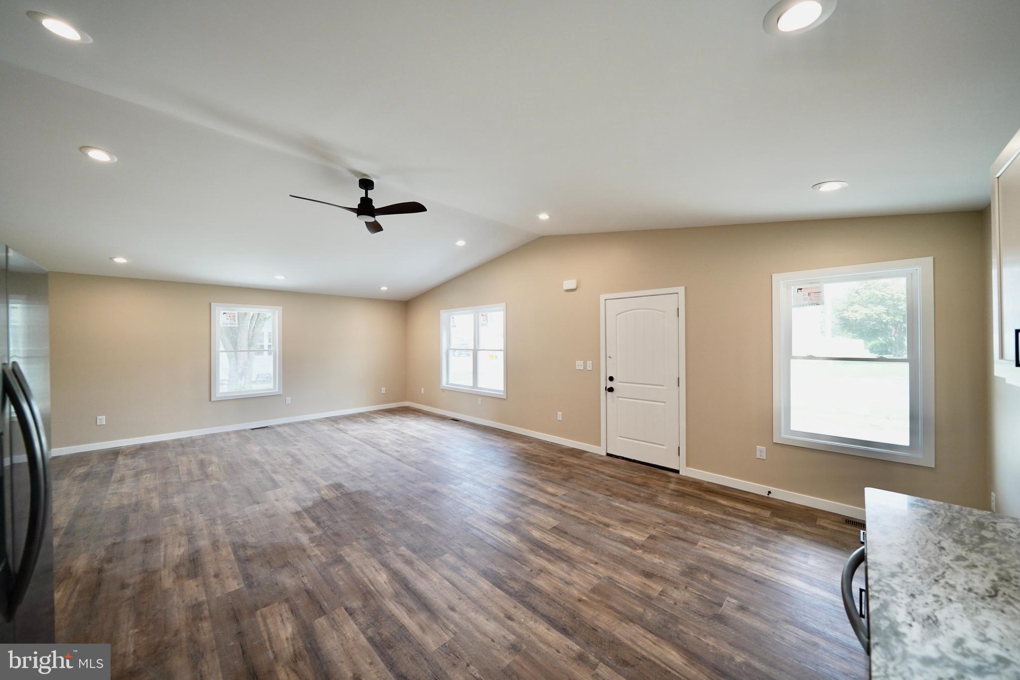 109 Main Street Ellendale, DE 19941 - Photo 11 of 29 an empty room with wooden floor and windows