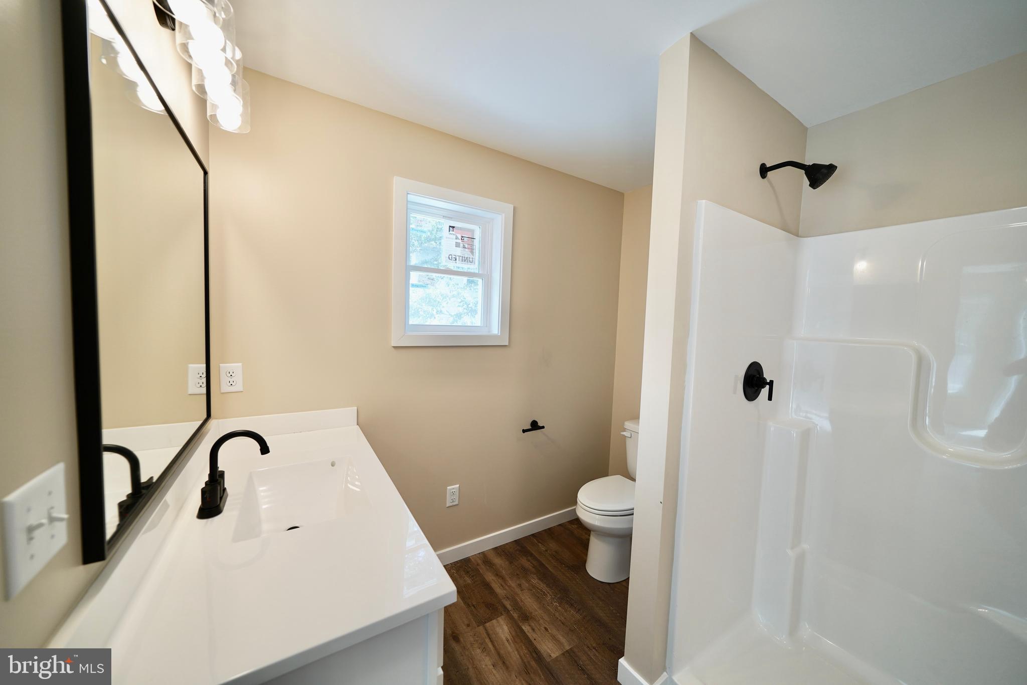 109 Main Street Ellendale, DE 19941 - Photo 21 of 29 a bathroom with a sink a toilet and shower