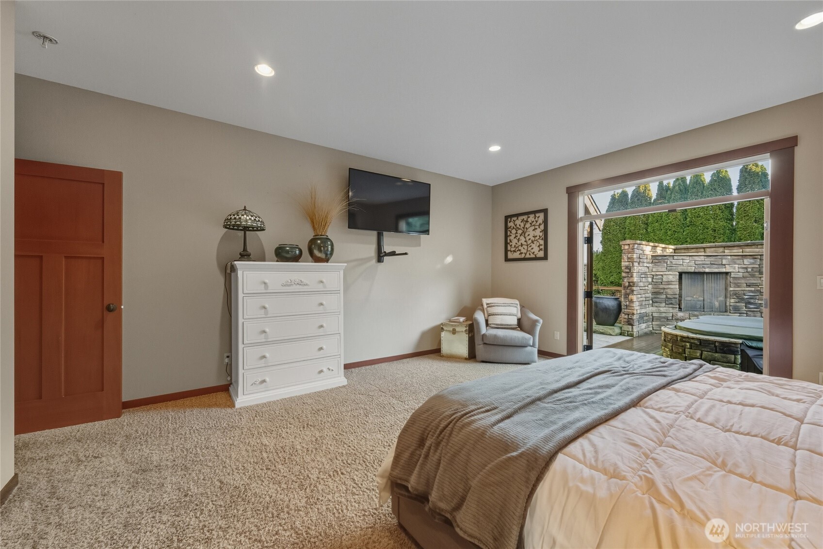 8424 Double Ditch Road Lynden, WA 98264 - Photo 15 of 39 a bedroom with a large bed and a flat tv screen on dresser