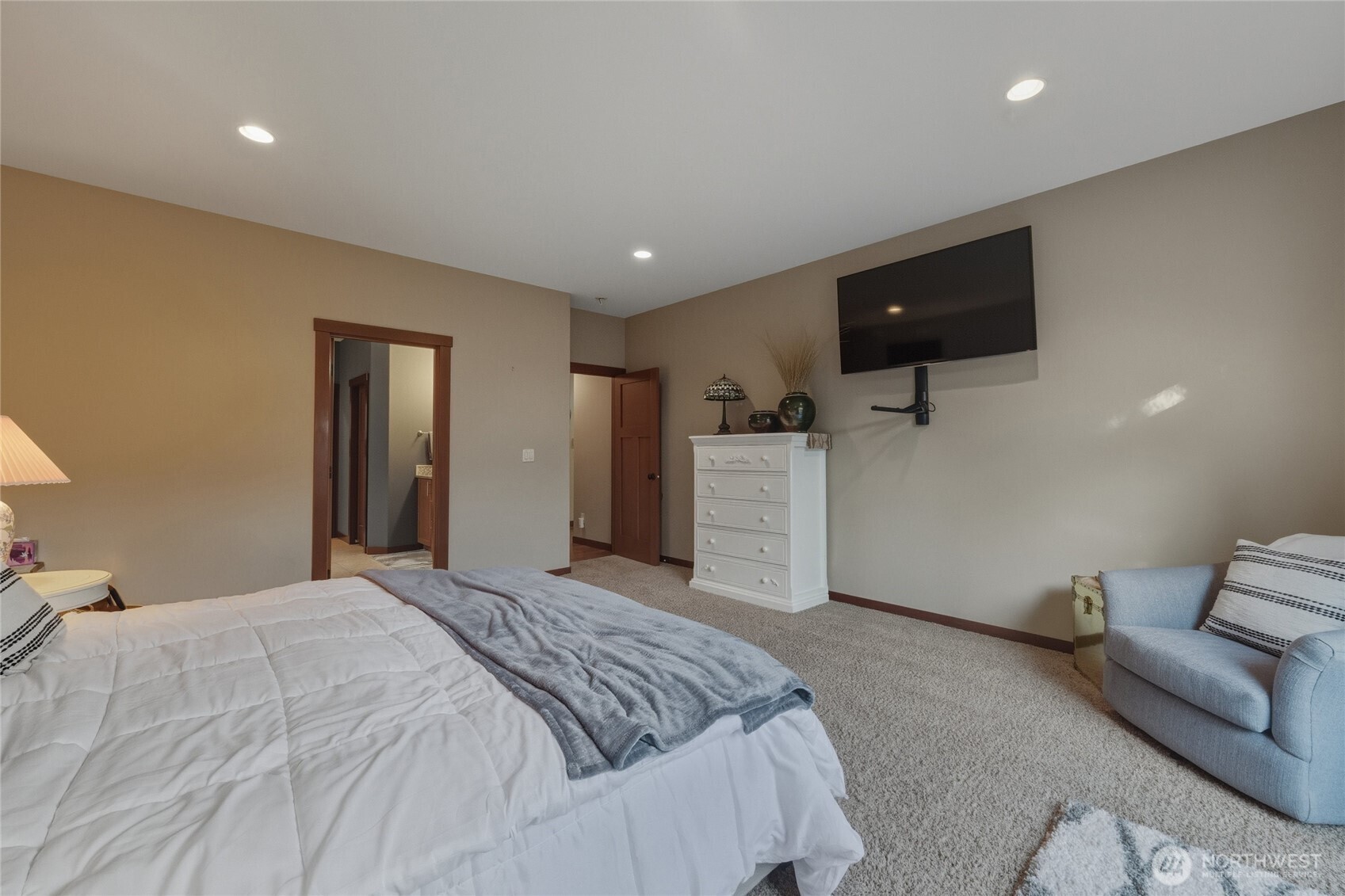 8424 Double Ditch Road Lynden, WA 98264 - Photo 22 of 39 a spacious bedroom with a bed and a flat screen tv
