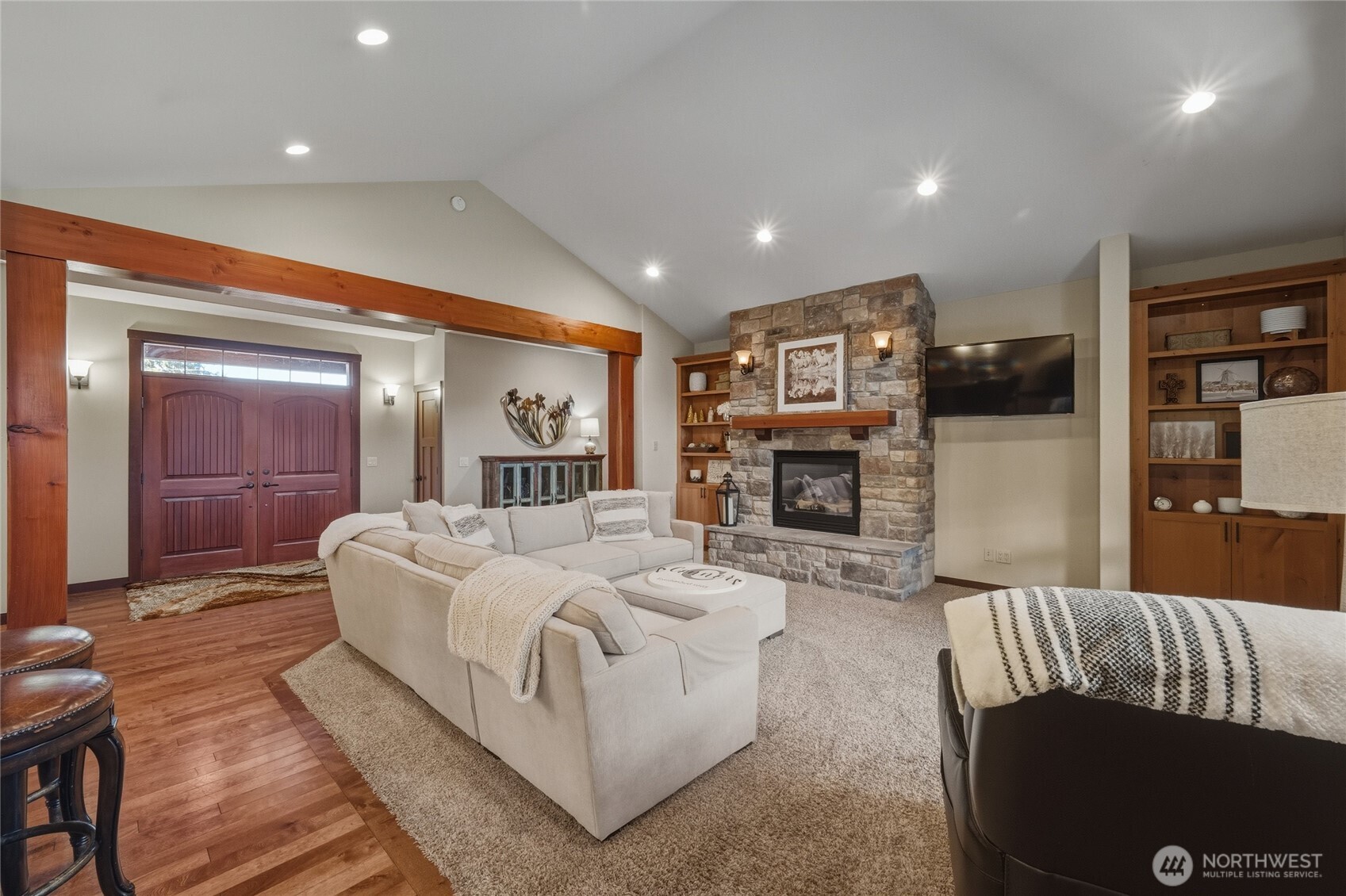 8424 Double Ditch Road Lynden, WA 98264 - Photo 7 of 39 a spacious bedroom with a large bed a fireplace and a couch