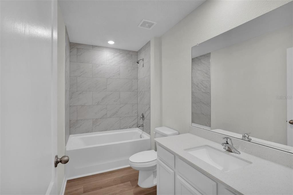 2 Prince Eric Lane Palm Coast, FL 32164 - Photo 18 of 24 a bathroom with a bathtub shower sink vanity and toilet