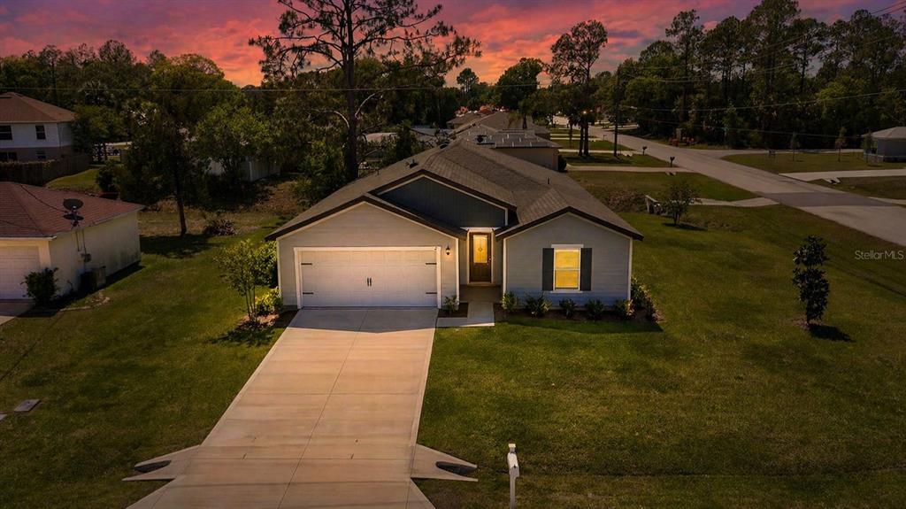 2 Prince Eric Lane Palm Coast, FL 32164 - Photo 2 of 24 a car parked in front of house with a yard