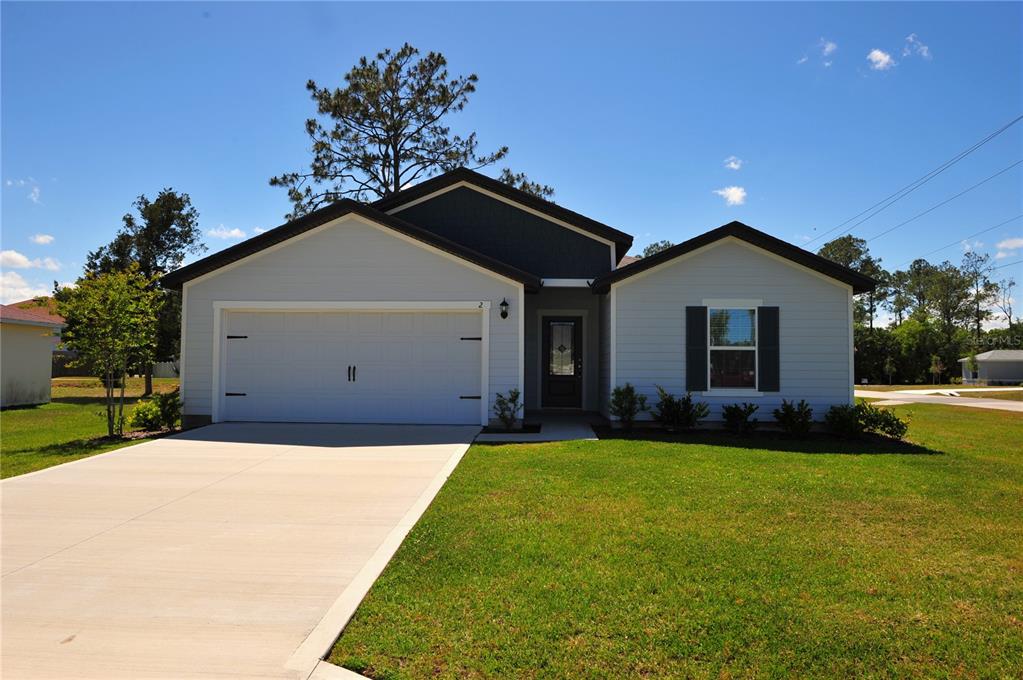 2 Prince Eric Lane Palm Coast, FL 32164 - Photo 21 of 24 a front view of a house with a yard and garage
