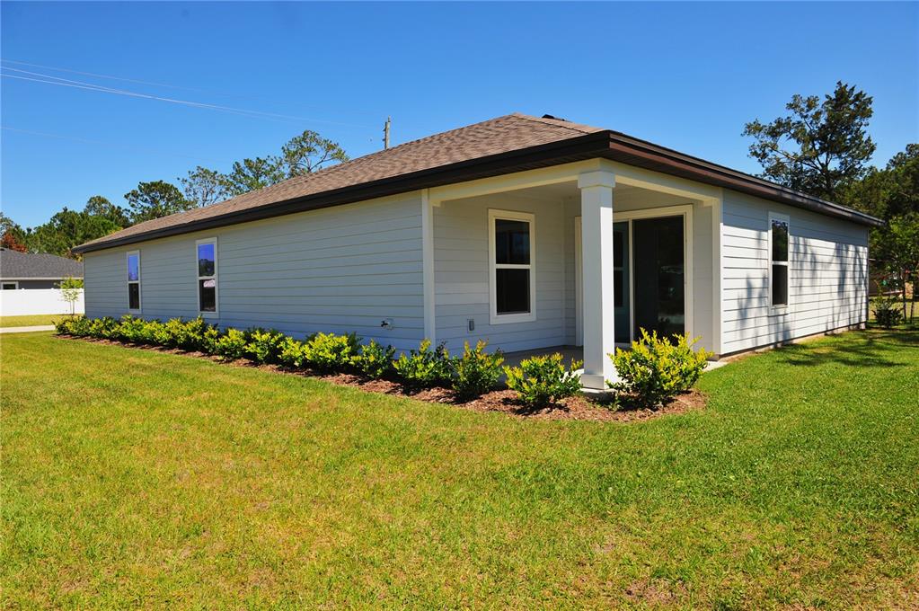 2 Prince Eric Lane Palm Coast, FL 32164 - Photo 3 of 24 a front view of house with yard and trees