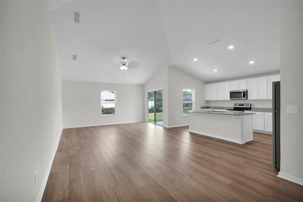 2 Prince Eric Lane Palm Coast, FL 32164 - Photo 6 of 24 a view of kitchen with granite countertop refrigerator oven and white cabinets