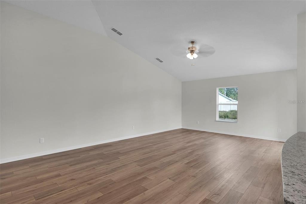2 Prince Eric Lane Palm Coast, FL 32164 - Photo 10 of 24 an empty room with wooden floor and windows