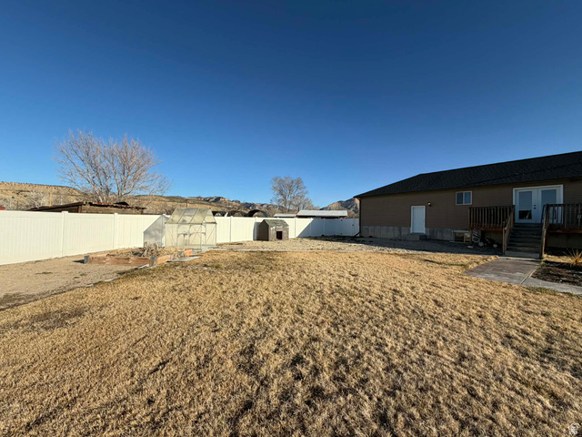 2095 West 4100 North Spring Glen, UT 84526 - Photo 24 of 35 Fenced backyard featuring an outdoor structure