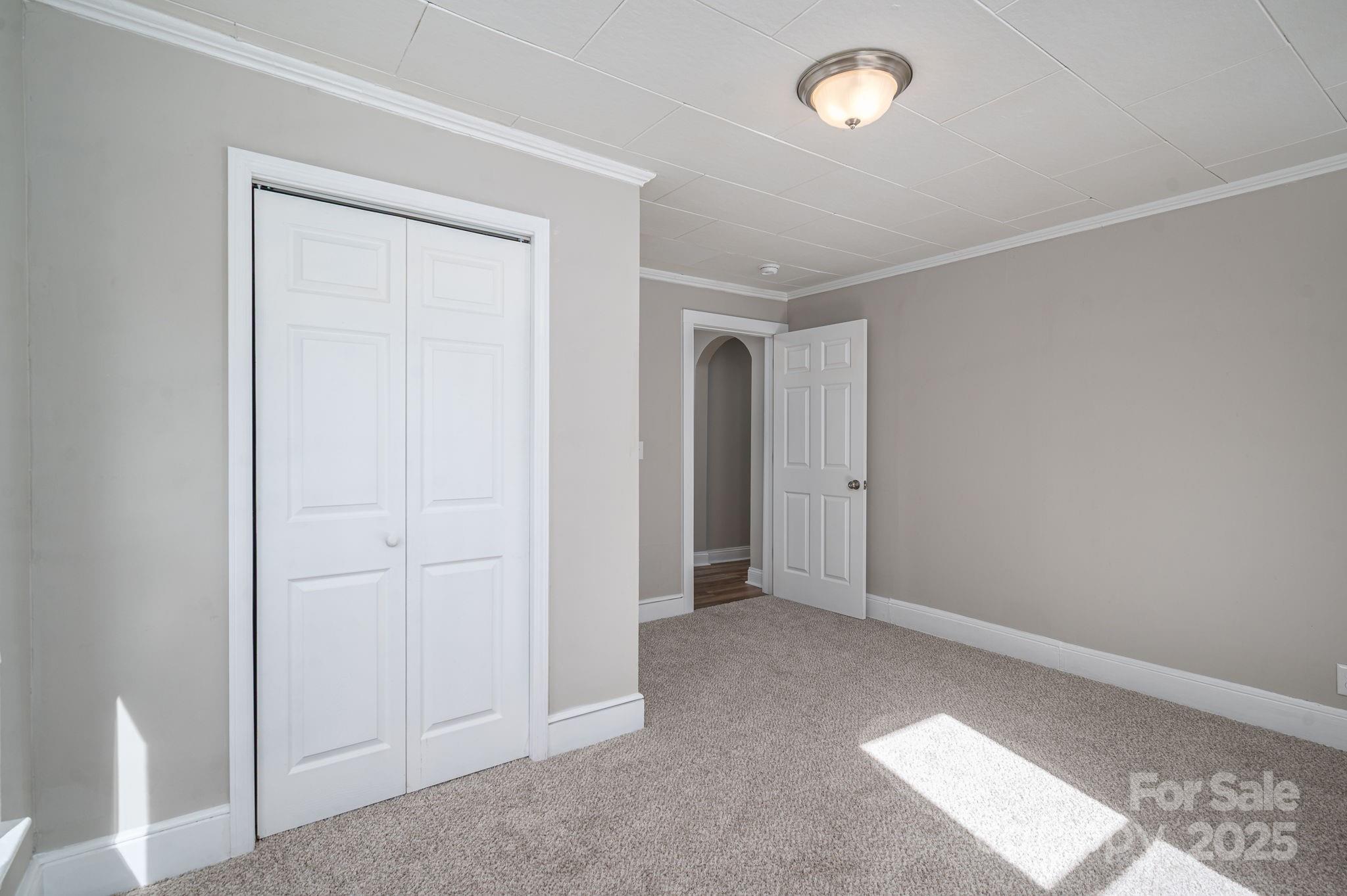 1811 Hemlock Avenue Gastonia, NC 28054 - Photo 17 of 31 an empty room with fan & hallway