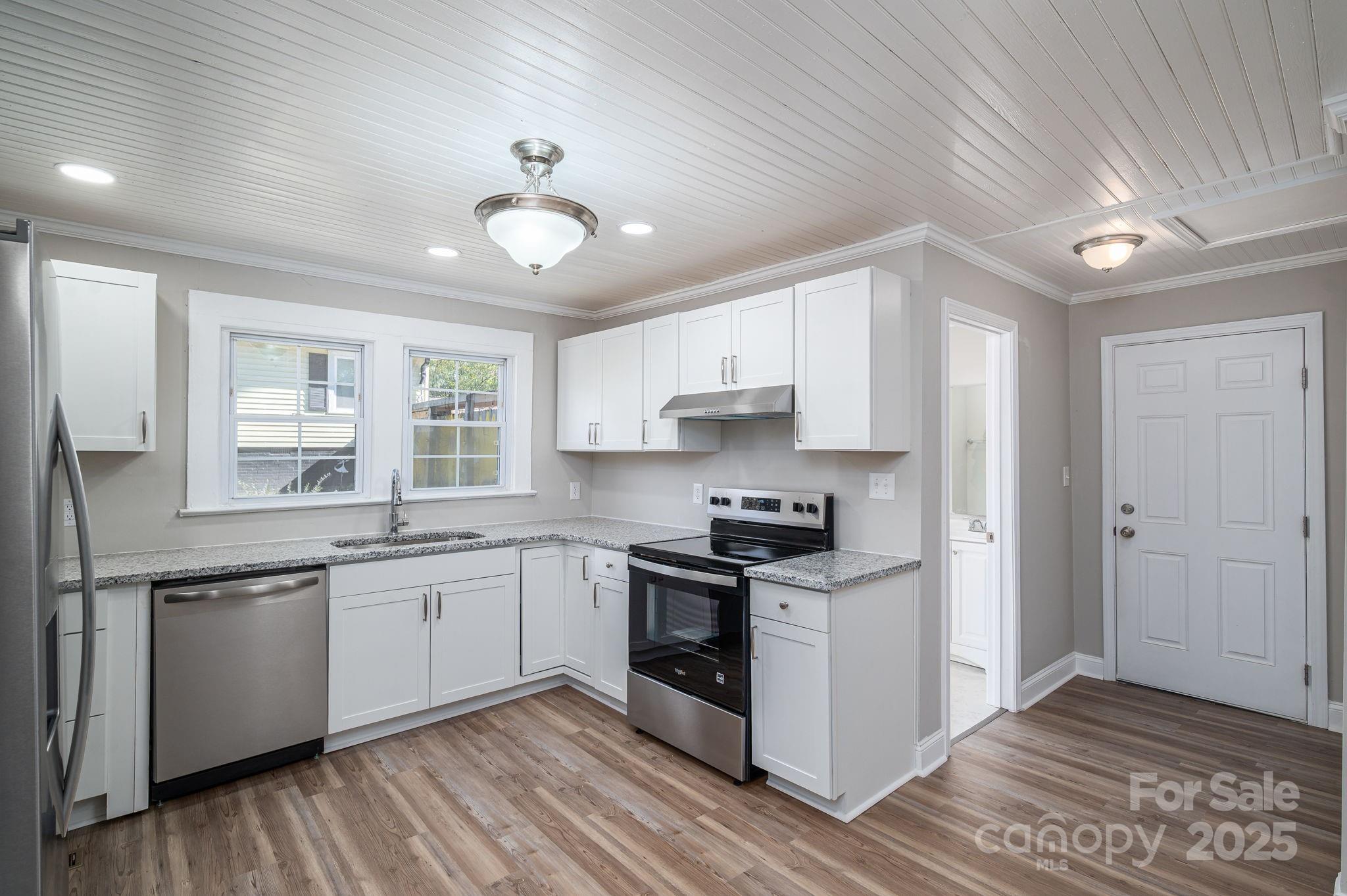 1811 Hemlock Avenue Gastonia, NC 28054 - Photo 20 of 31 a kitchen with stainless steel appliances granite countertop a sink stove and refrigerator