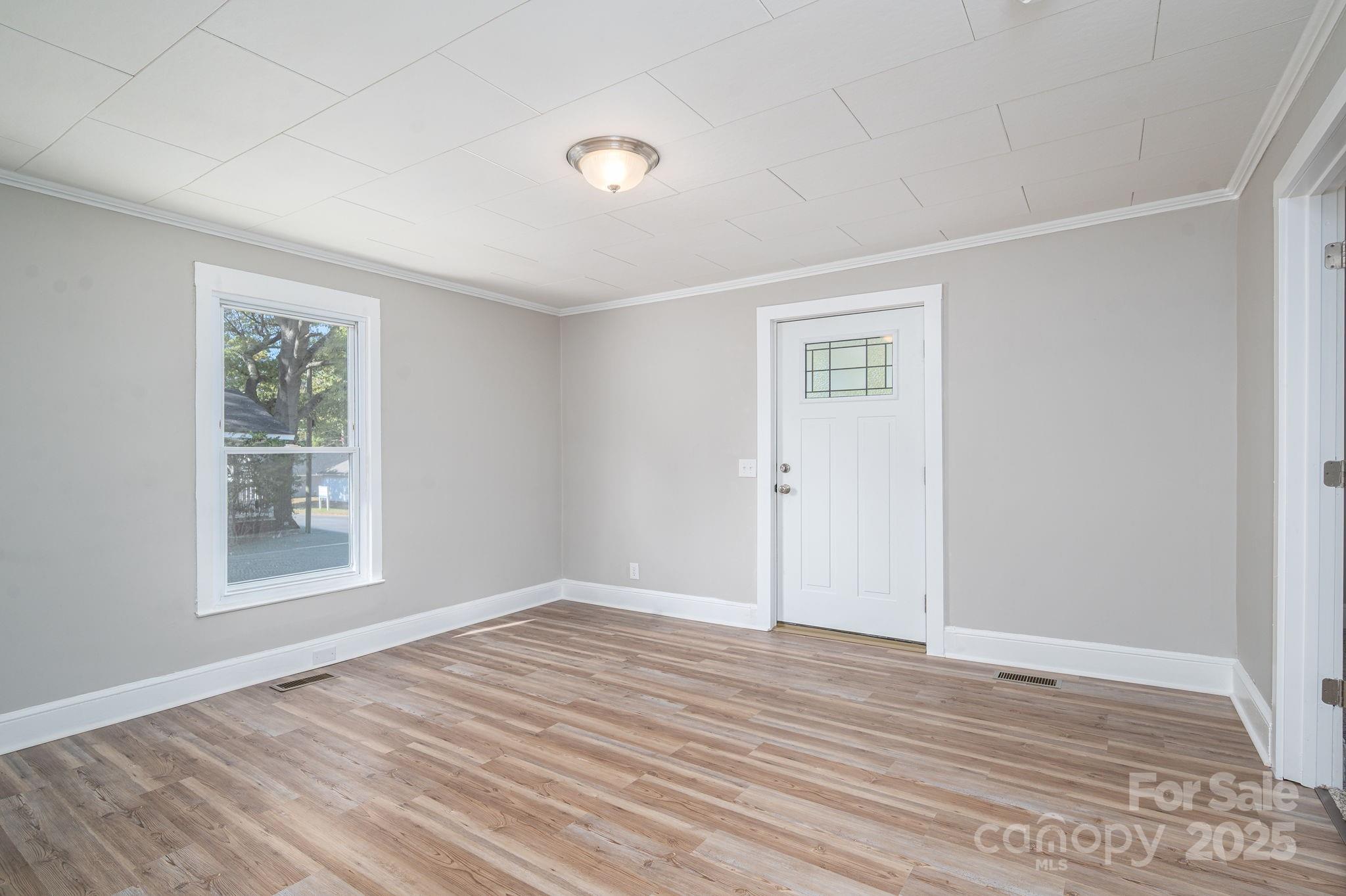 1811 Hemlock Avenue Gastonia, NC 28054 - Photo 9 of 31 a view of empty room with wooden floor and fan