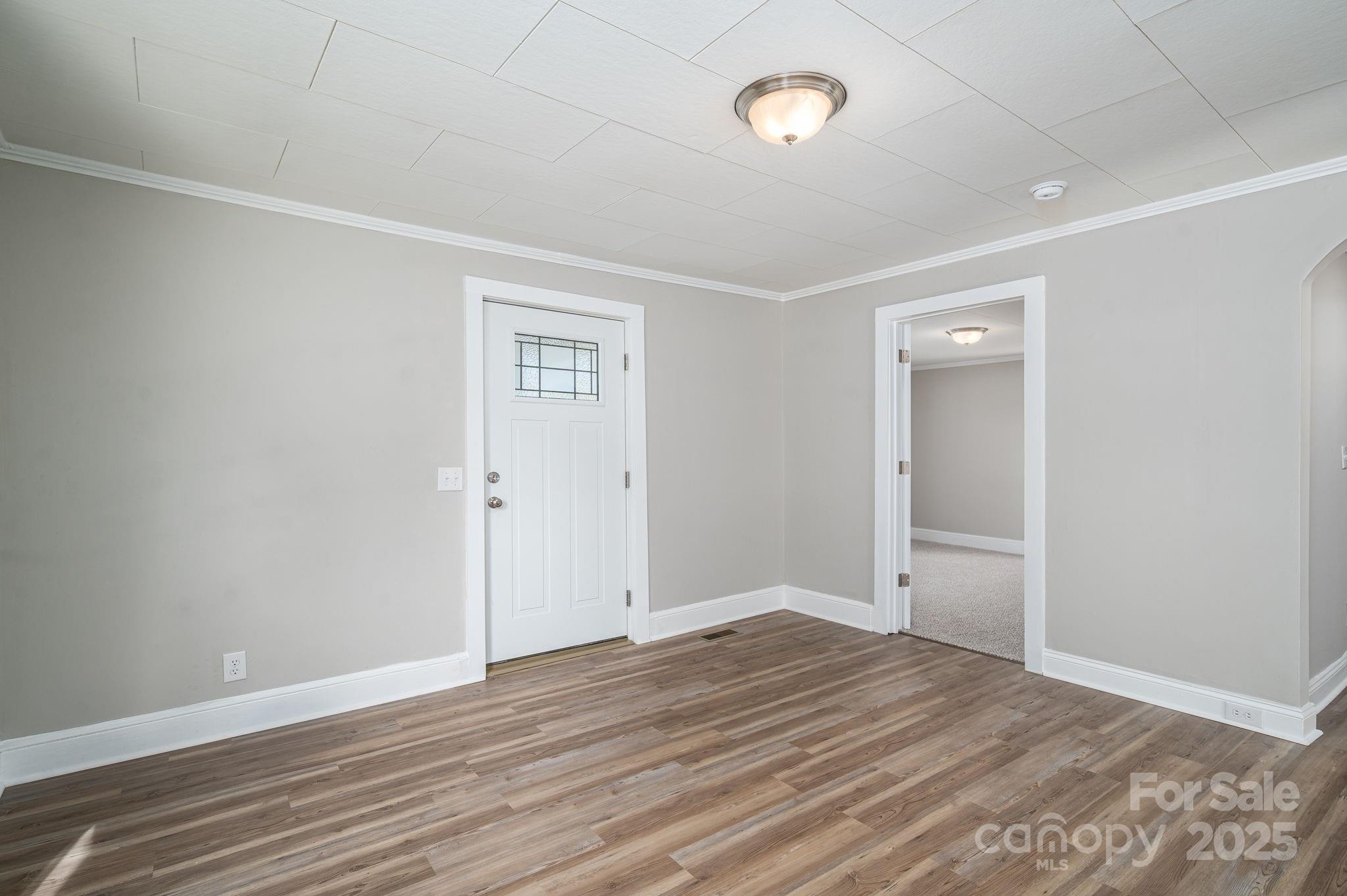 1811 Hemlock Avenue Gastonia, NC 28054 - Photo 10 of 31 an empty room with wooden floor and windows