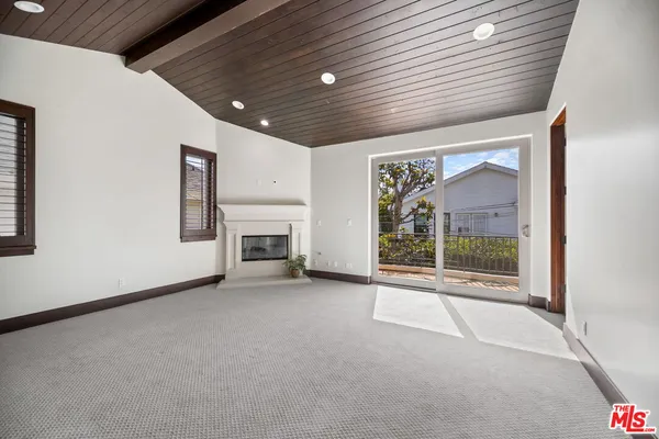 a view of a livingroom with an empty space and a fireplace