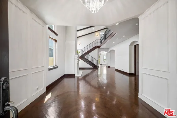 a view of an entryway with wooden floor