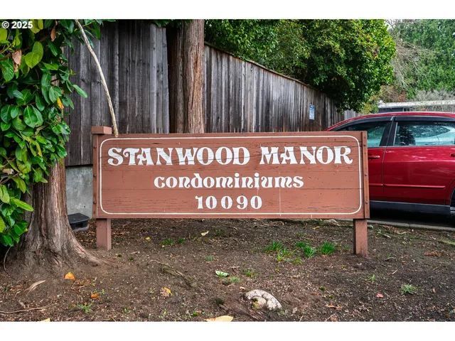 a sign broad in front of a house