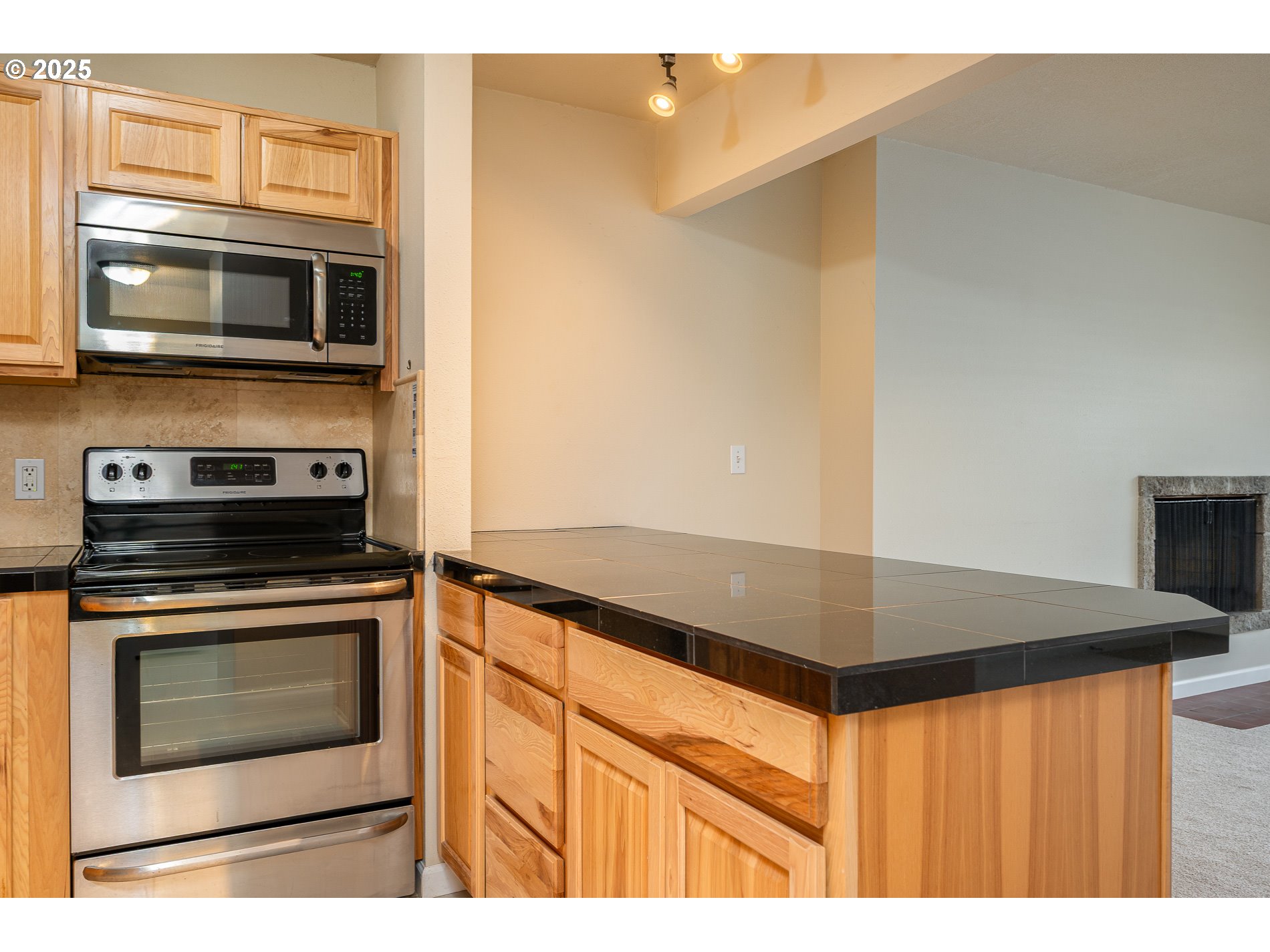 10090 Southwest Beaverton Hillsdale Highway, Unit 16 Beaverton, OR 97005 - Photo 12 of 39 a kitchen with granite countertop cabinets stainless steel appliances and a counter space