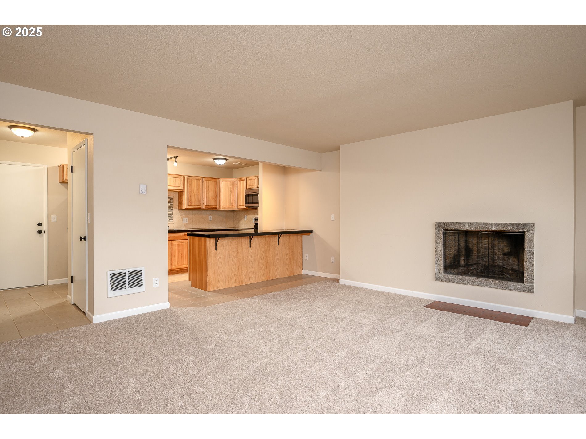 10090 Southwest Beaverton Hillsdale Highway, Unit 16 Beaverton, OR 97005 - Photo 2 of 39 view of an empty room with a fireplace and a window